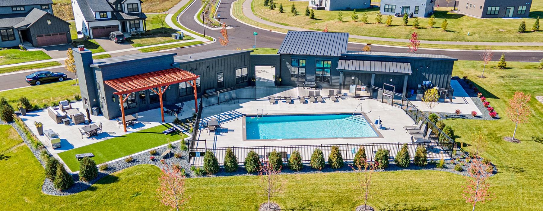 a building with a pool in the middle of a field