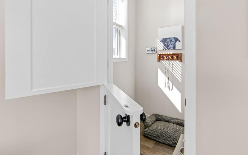 a white room with a white cabinet and a white door