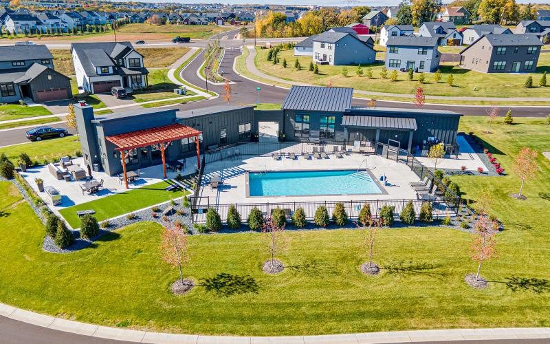 a building with a pool in the middle of a field